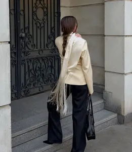 Satin tie-up waist belt with long fringe details shown on a model in a stylish blazer