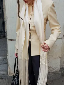 Detailed shot of an elegant cream satin waist belt with long fringes and knots