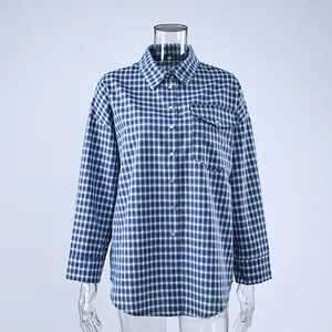 Detailed macro view of the blue and white plaid cotton shirt with chest pocket and buttons