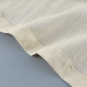 Detailed close-up of breathable linen fabric and hem stitching for a French style shirt