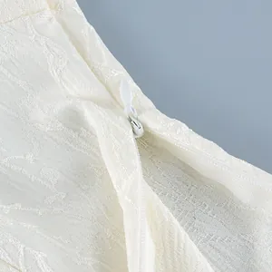 Detail of invisible zipper on white jacquard fabric of a modern Chinese style shirt.