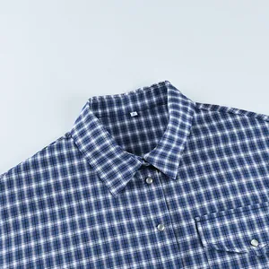 Close-up detail of the collar and buttons on a classic blue plaid cotton shirt for women.