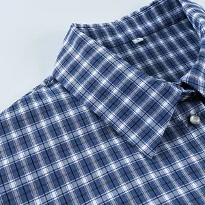 Detailed close-up showing the collar and texture of a blue and white plaid shirt