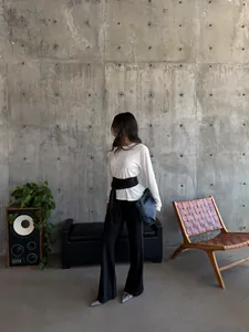 Fashionable black satin tassel belt styled on a model for a chic waist-cinching look