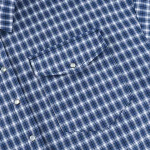 Detail view of a blue and white checkered cotton shirt with pocket and pearl buttons