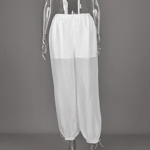 Detailed view of white semi-transparent loose drawstring trousers with striped texture