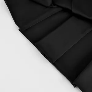 Close-up of high-quality pleated black fabric showing fine texture and clean folds.