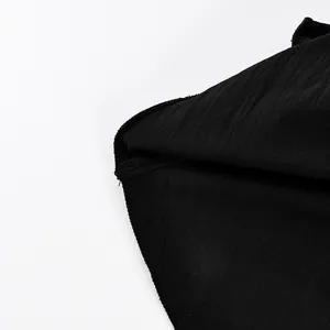 Macro detail showing the high-quality stitching and fabric texture of the black tiered skirt.