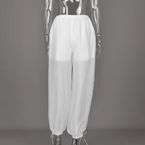 Back view of elegant white semi-transparent loose pants featuring drawstring hem detail
