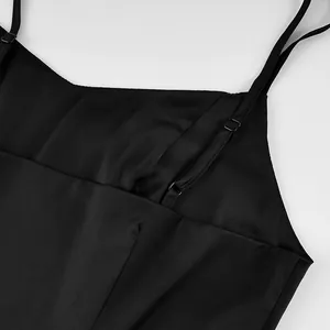 Detailed view of black slim-fit camisole featuring adjustable thin spaghetti straps.