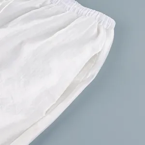 Close-up of white semi-transparent drawstring pants featuring a striped texture.