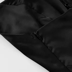 Close-up detail showing the high-quality invisible zipper on a black satin camisole.