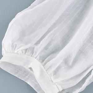 Detailed macro view of white semi-sheer striped fabric for lightweight summer pants
