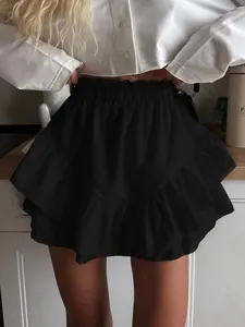 Detailed view of a high-waisted black tiered ruffle mini skirt for a stylish look