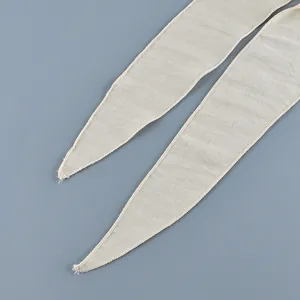 Close-up of the pointed ends of fabric waist ties for a French wrap blouse.