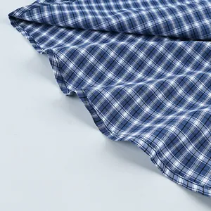 Detail view of the blue and white checkered texture on a vintage cotton plaid shirt.