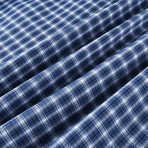 Close-up of blue and white vintage plaid fabric texture showing soft cotton weave