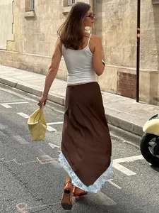 Elegant brown midi skirt with light blue lace trim shown in a street setting.