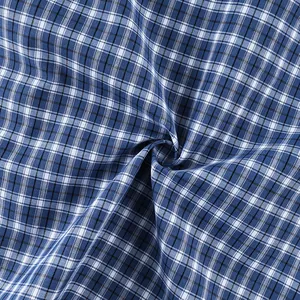 Detailed macro shot of vintage blue and white checkered plaid cotton shirt fabric texture.