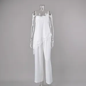 Elegant white two-piece pajama set featuring lace-trimmed camisole and matching straight trousers