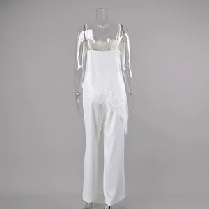 Detailed back view of white lace camisole and straight trousers set on clear mannequin.