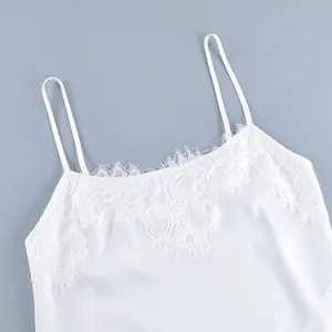Detailed view of elegant white camisole with delicate eyelash lace trim and thin straps