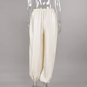 Back view of elegant cream satin lantern pants featuring comfortable elastic waistband.