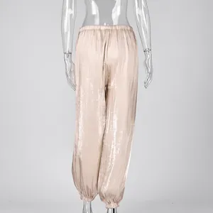 Back view of shimmering champagne lantern pants with elastic waist and cuffed hem.