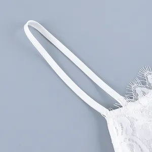 Close-up view showing the delicate white eyelash lace detailing and fine strap of a top