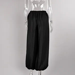 Detailed back view of elegant black satin lantern pants featuring comfortable elastic waist