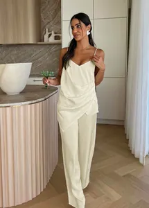 Detail of cream satin two-piece set with draped camisole and wide-leg trousers