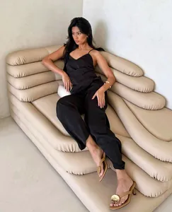 Elegant Asian model wearing a black satin camisole and straight-leg trousers set