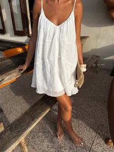Relaxed fit white V-neck camisole mini dress for a breezy summer vacation look.