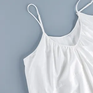 Close-up of white V-neck spaghetti strap dress showing linen fabric texture and M size tag