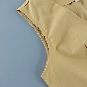 Macro view showing the armhole and cotton linen fabric texture of a mustard vest