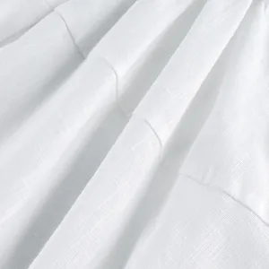 Close-up of high-quality white linen fabric texture on a summer vacation mini dress.