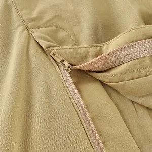 Detailed close-up showing the high-quality zipper and khaki linen fabric texture.