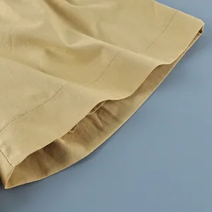 Close-up of cotton linen hem showing fine stitching and natural fabric texture