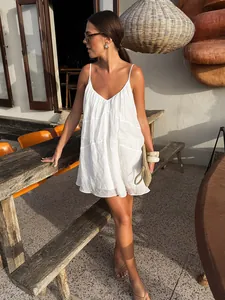 Elegant white V-neck spaghetti strap mini dress for summer resort vacation wear.