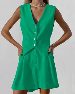 Close-up of bright green linen-cotton vest and shorts set showing fabric texture and buttons
