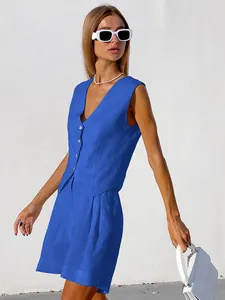 Chic blue cotton linen vest and shorts set shown on a model against white wall