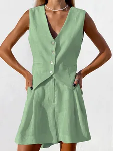 Close-up detail of a sage green cotton linen vest and pleated shorts set for women