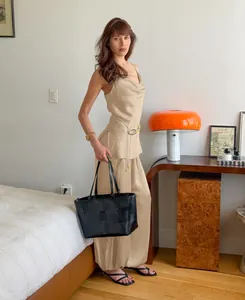 Elegant champagne satin camisole and wide-leg trouser two-piece set on a model