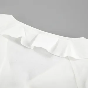 Detailed view of the elegant ruffle neckline on a white cotton linen V-neck summer top