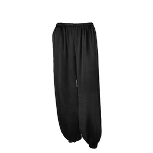Vista dettagliata dei pantaloni casual neri larghi con vita e polsini elastici.