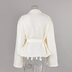 Detailed back view of the cream frosted velvet trench coat showing the waist belt