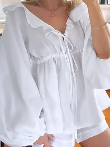Elegant white cotton linen two-piece set with puff sleeves and ruffle detail.