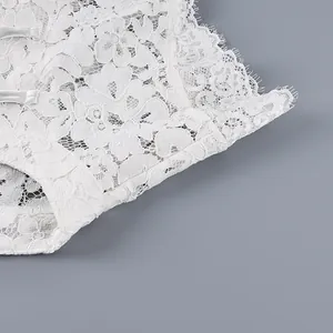 Détail de la texture de dentelle florale blanche et des boutons traditionnels chinois