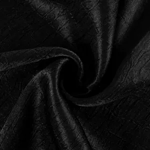 Dettaglio ravvicinato della trama raffinata del tessuto nero per pantaloni alla moda.