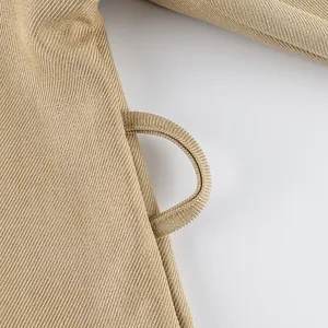 Close-up detail showing the high-quality twill fabric and belt loop of the khaki trench coat